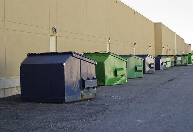 a stack of yellow construction dumpsters on a job site in Alamo Heights, TX